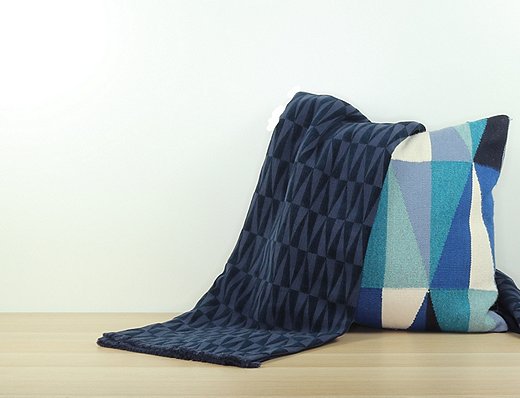 An Apex throw, handwoven in Portugal, with a Harmoni pillow, handwoven in Peru.
